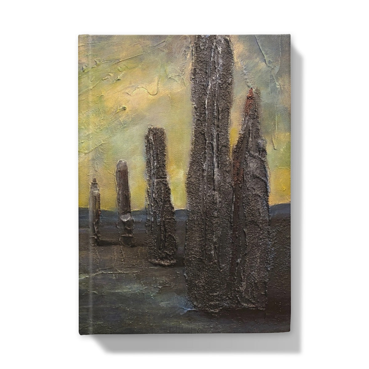 Black stone totem pole wall art on yellow background in Brodgar journal