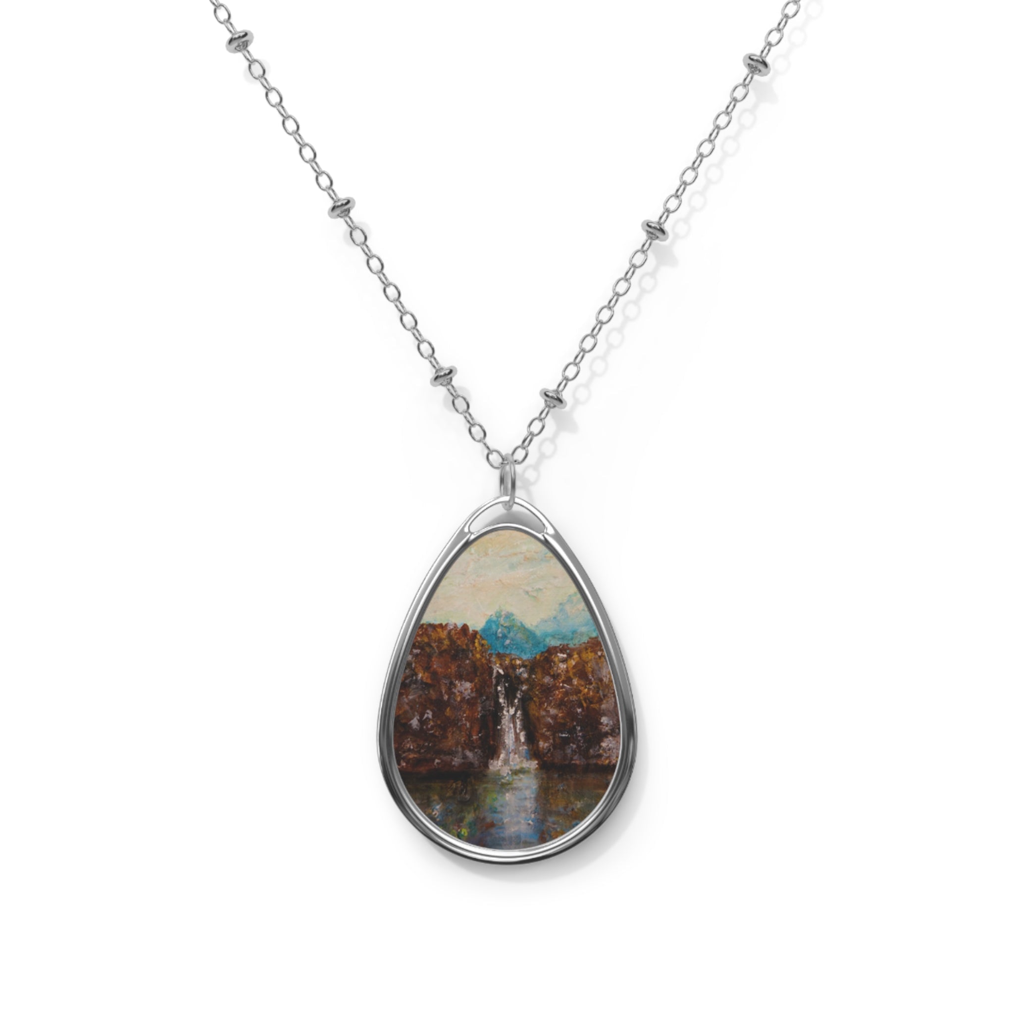 Silver chain necklace with oval pendant showcasing a painted waterfall scene from The Fairy Pools Skye Scottish Jewellery