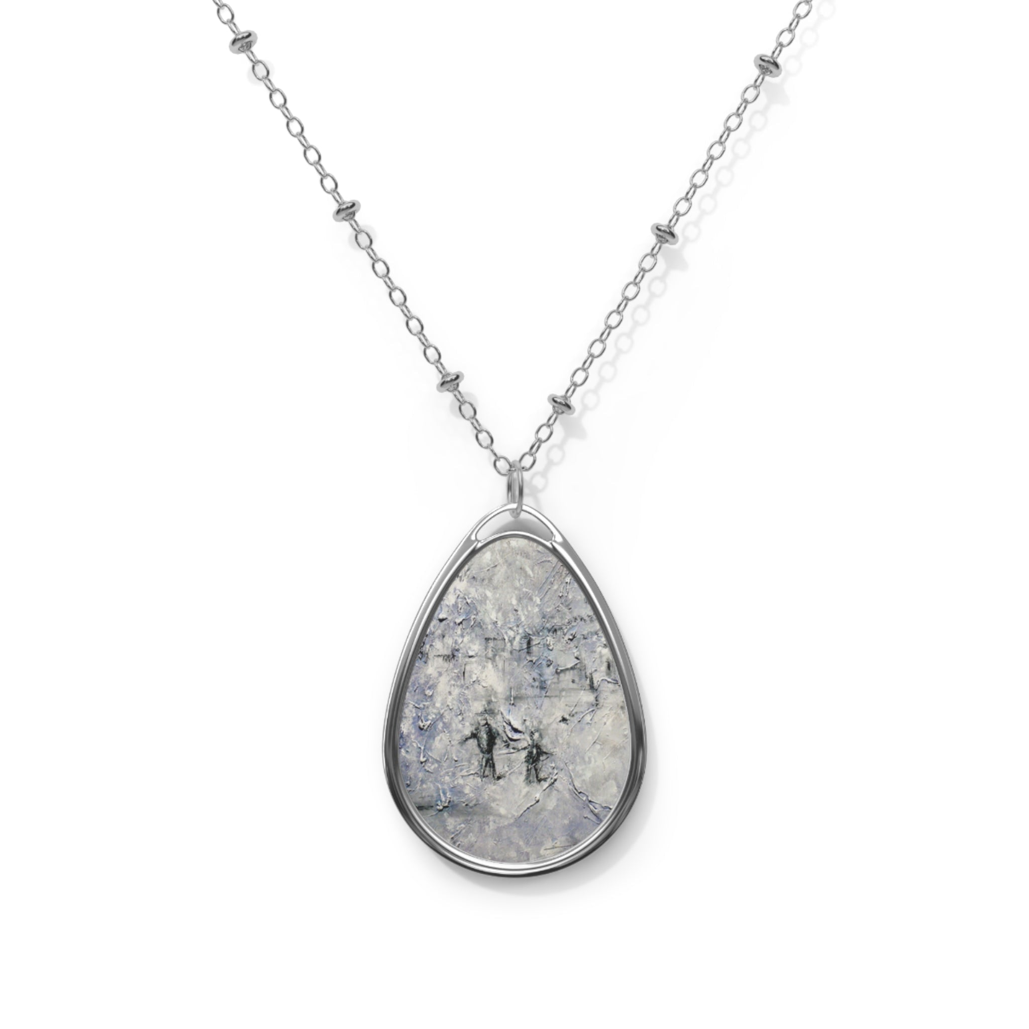 Silver chain necklace with teardrop-shaped pendant featuring textured black, white, and gray Scottish art design