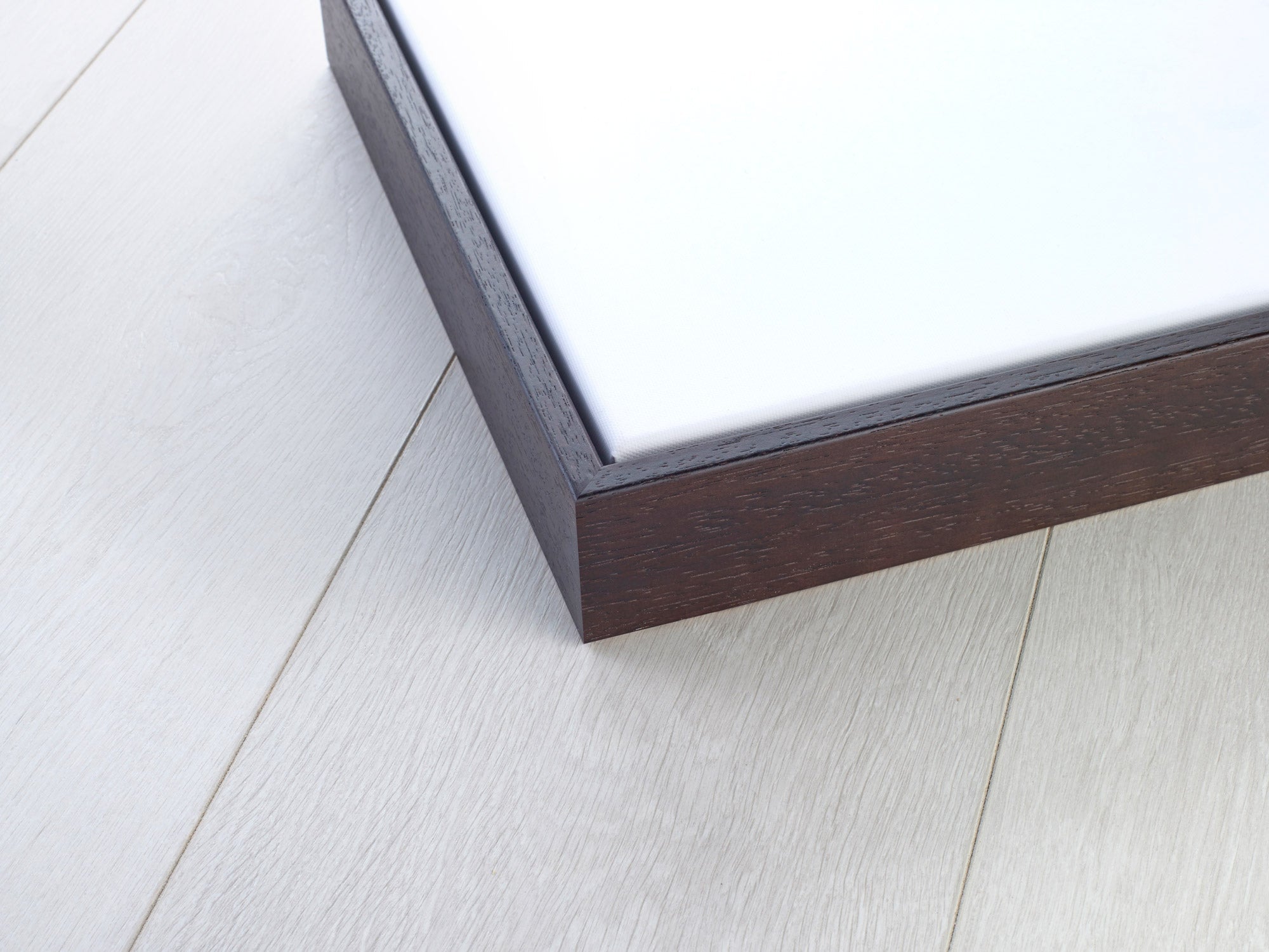 Modern white cushioned bed in dark brown floating frame