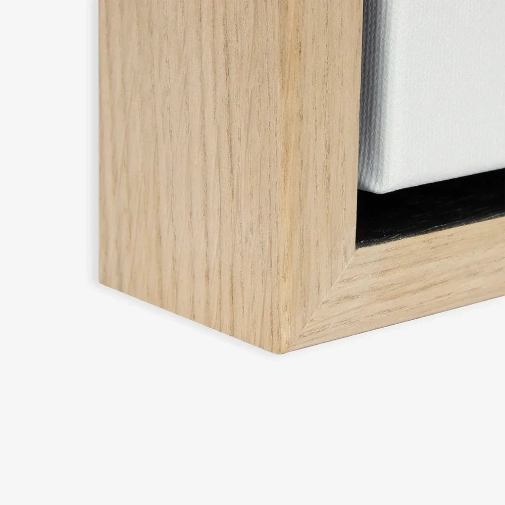 Modern light oak floating frame with white cushion and black base