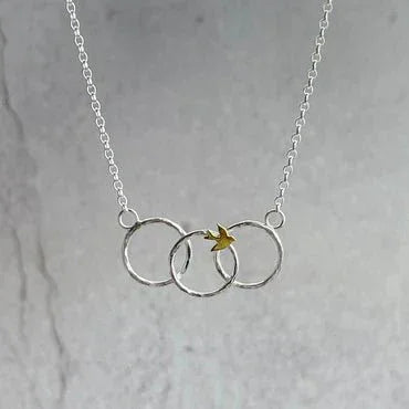 Fly Away Necklace with interlocking silver rings and gold leaf charm by Lindsay Mcdowall Jewellery