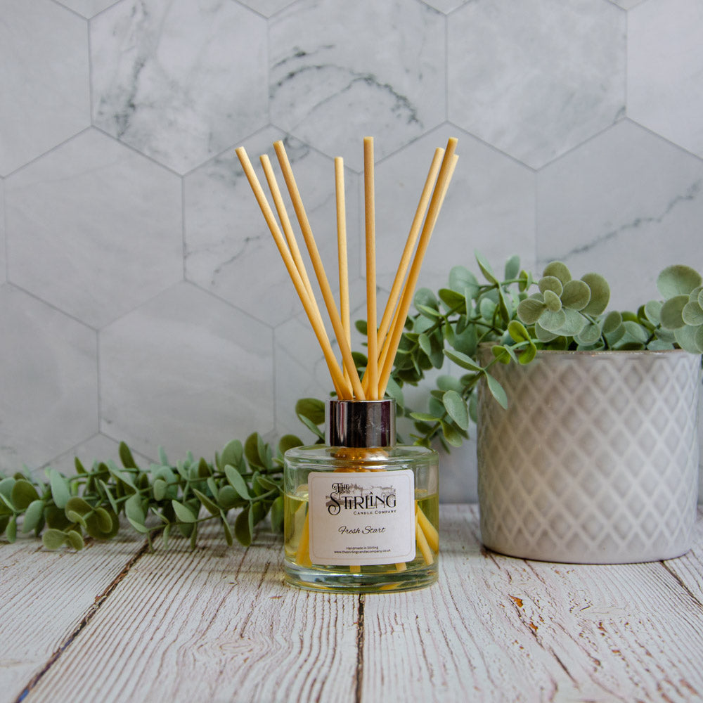 Fresh Start 100ml diffuser with golden-yellow liquid and wooden reeds