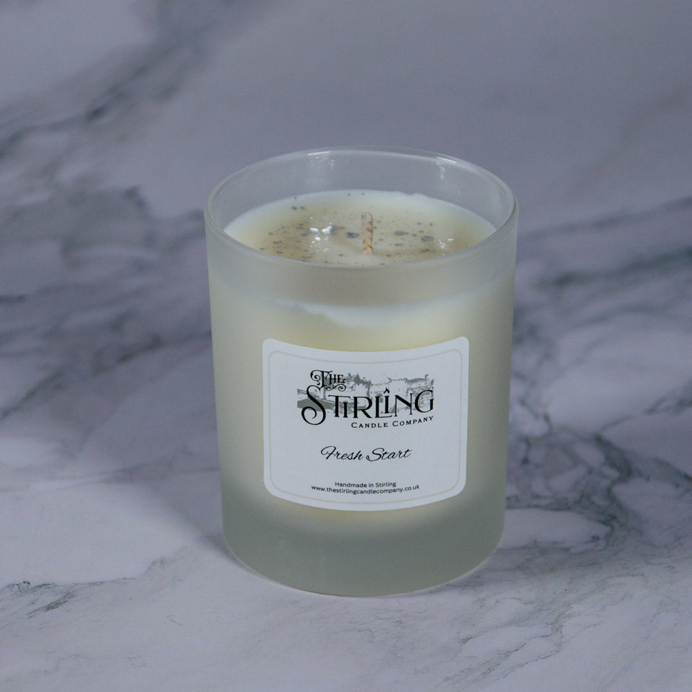 Fresh Start medium candle in frosted glass jar with creamy white wax by Stirling Candle Company