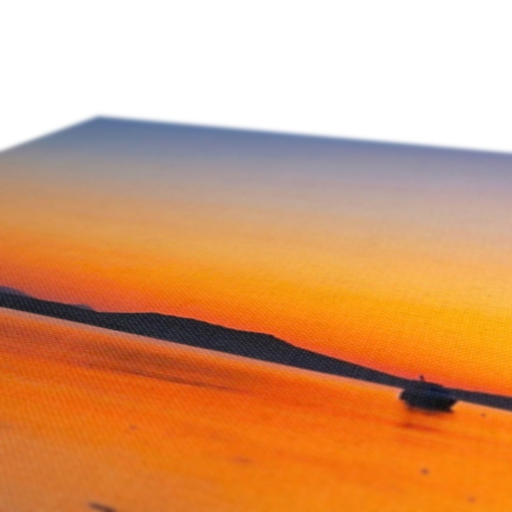 Gigha and Jura orange sunset beach scene with small boat canvas print