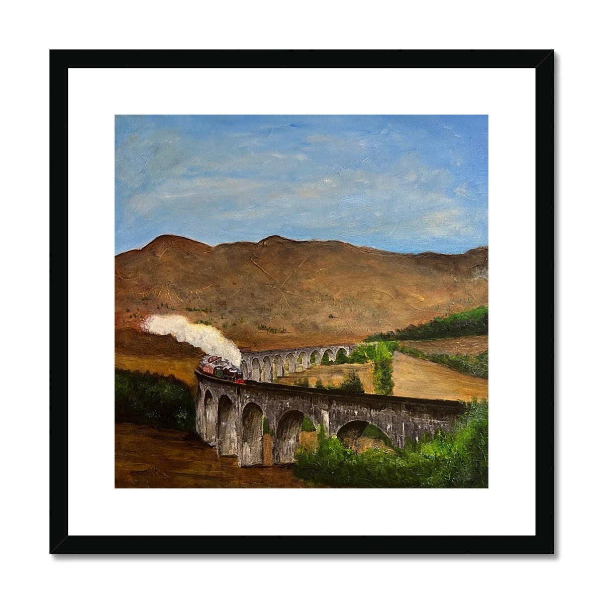 Framed print of a red steam train on Glenfinnan Viaduct in a scenic hilly landscape