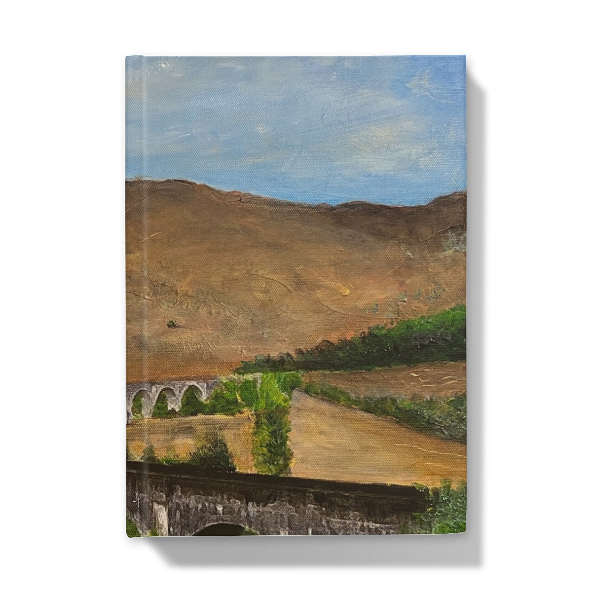 Glenfinnan Viaduct brown stone bridge with arches and greenery journal