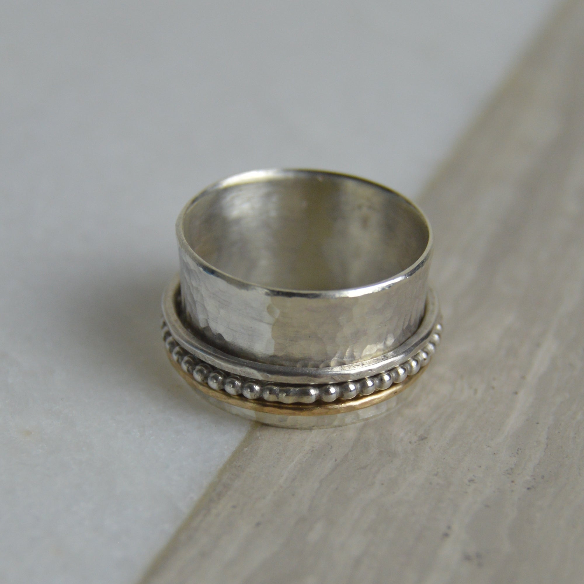 Gold fill beaded spinning ring with hammered silver bands by Lindsay Mcdowall Jewellery