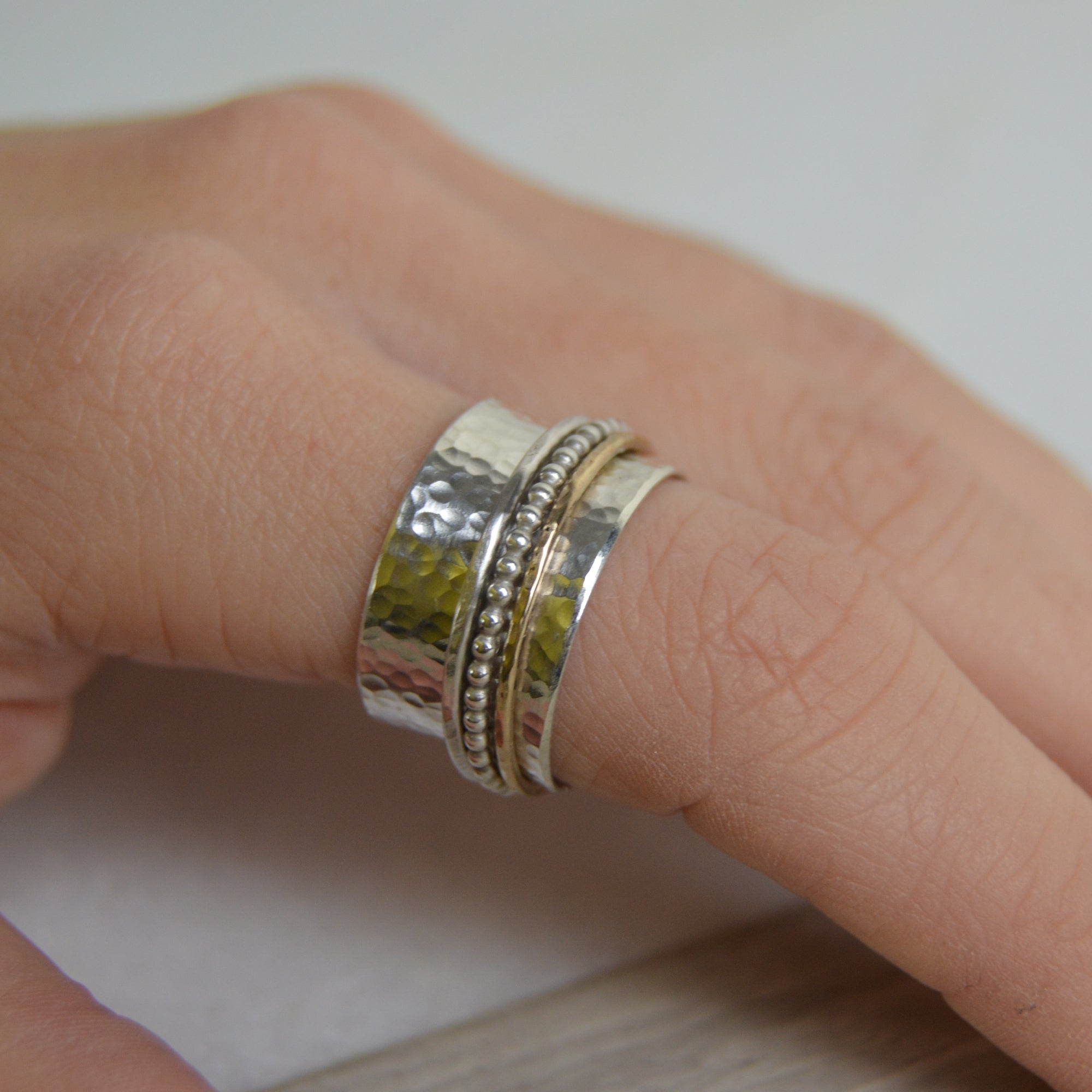 Silver hammered spinner ring with beaded center band, gold fill