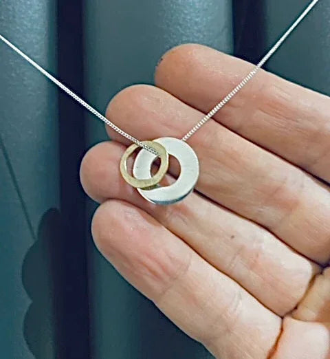 Delicate silver and gold interlocking circle pendant from Genna Miller Jewellery