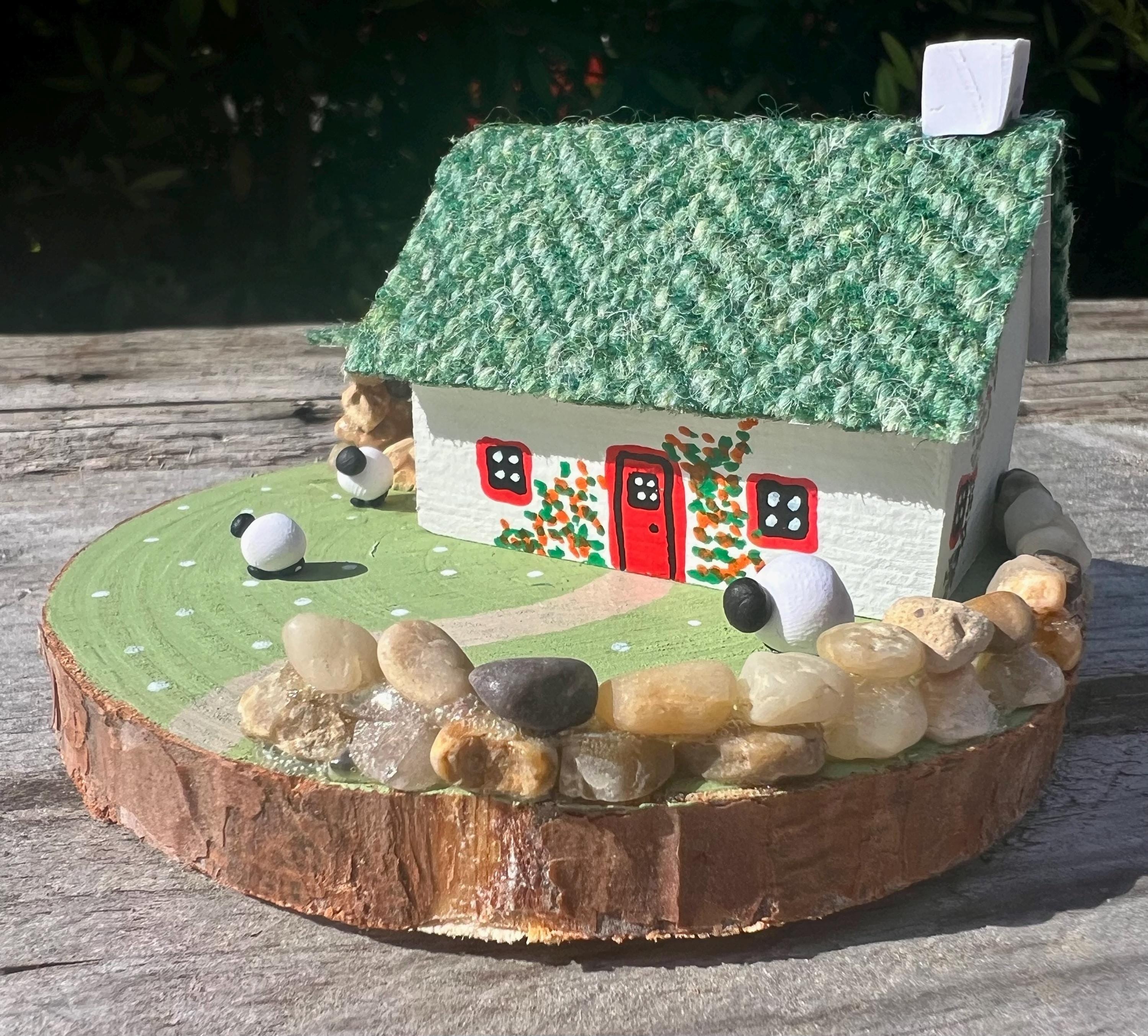 Handmade miniature Irish cottage with a thatched green roof and stone wall for Green Harris Tweed Miniature Scottish Bothy