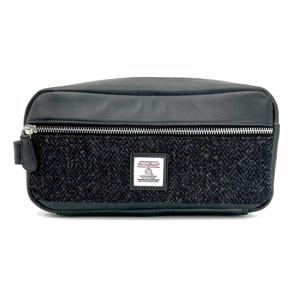 Charcoal Harris Tweed toiletry bag with herringbone pattern and leather trim