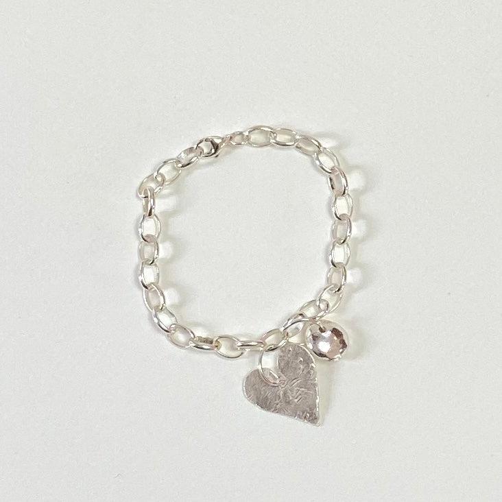 Silver chain bracelet with textured heart charm and small spherical pendant in heart and nugget bracelet design