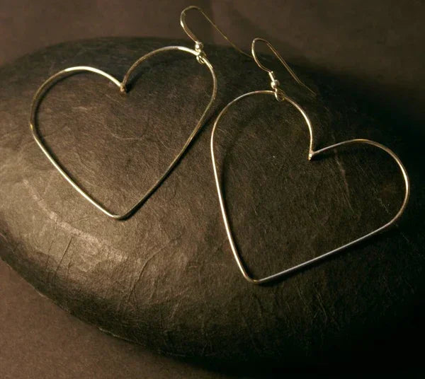 Silver heart-shaped hoop earrings by Genna Miller Jewellery