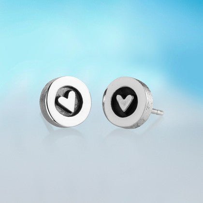 Silver stud earrings with minimalist heart design and polished metallic finish in heart silver earrings product