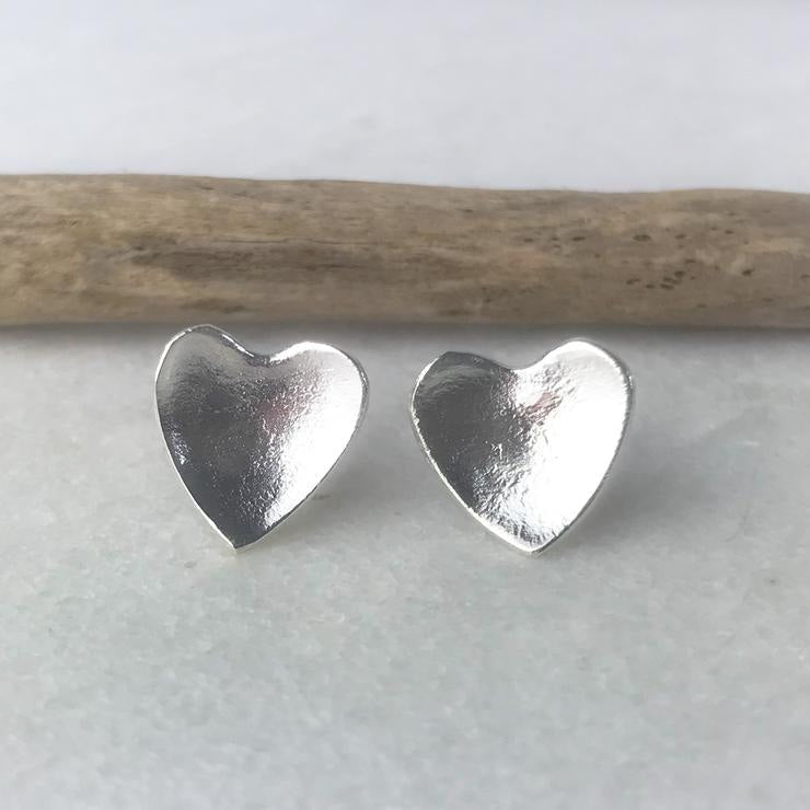 Silver heart-shaped stud earrings with matte textured finish by Lindsay Mcdowall Jewellery