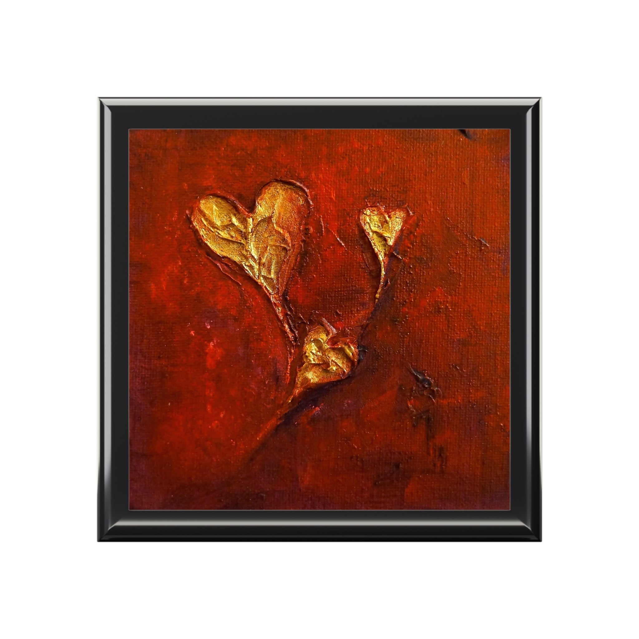Abstract framed art with three gold heart shapes on textured deep red background in Scotland