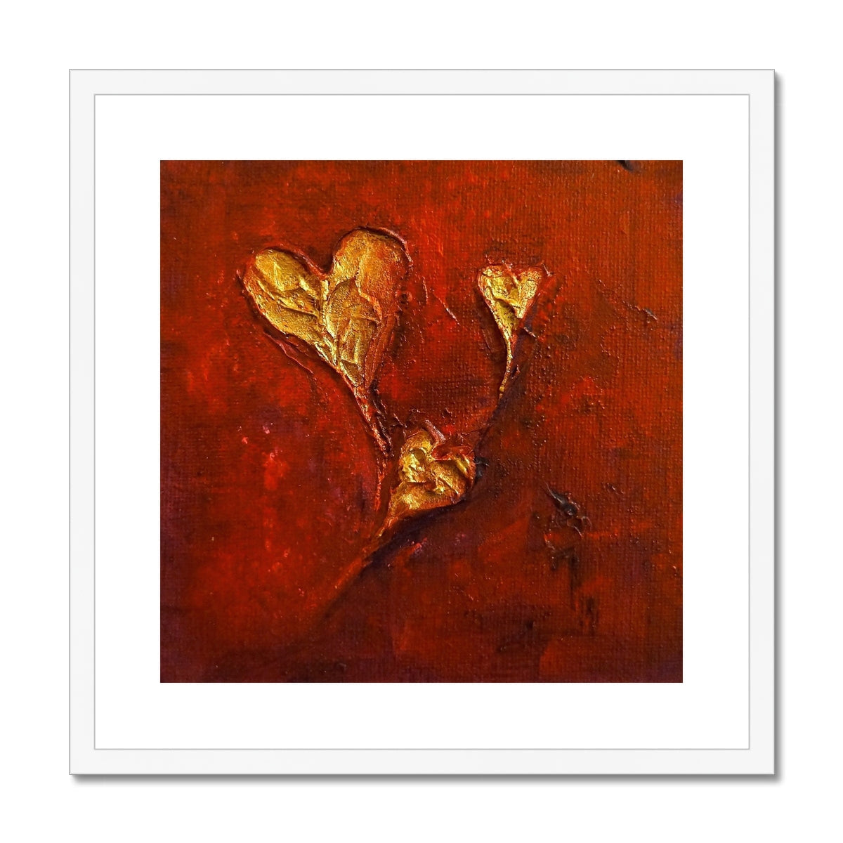 Gold heart-shaped pendant necklace on red background, white frame