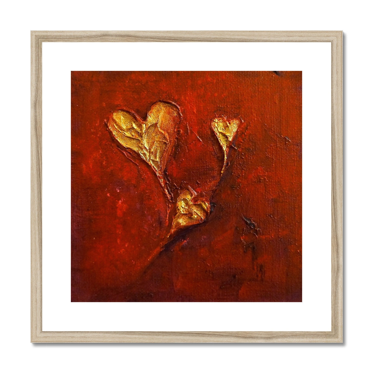 Gold heart-shaped wall art with textured surface in off-white wooden frame