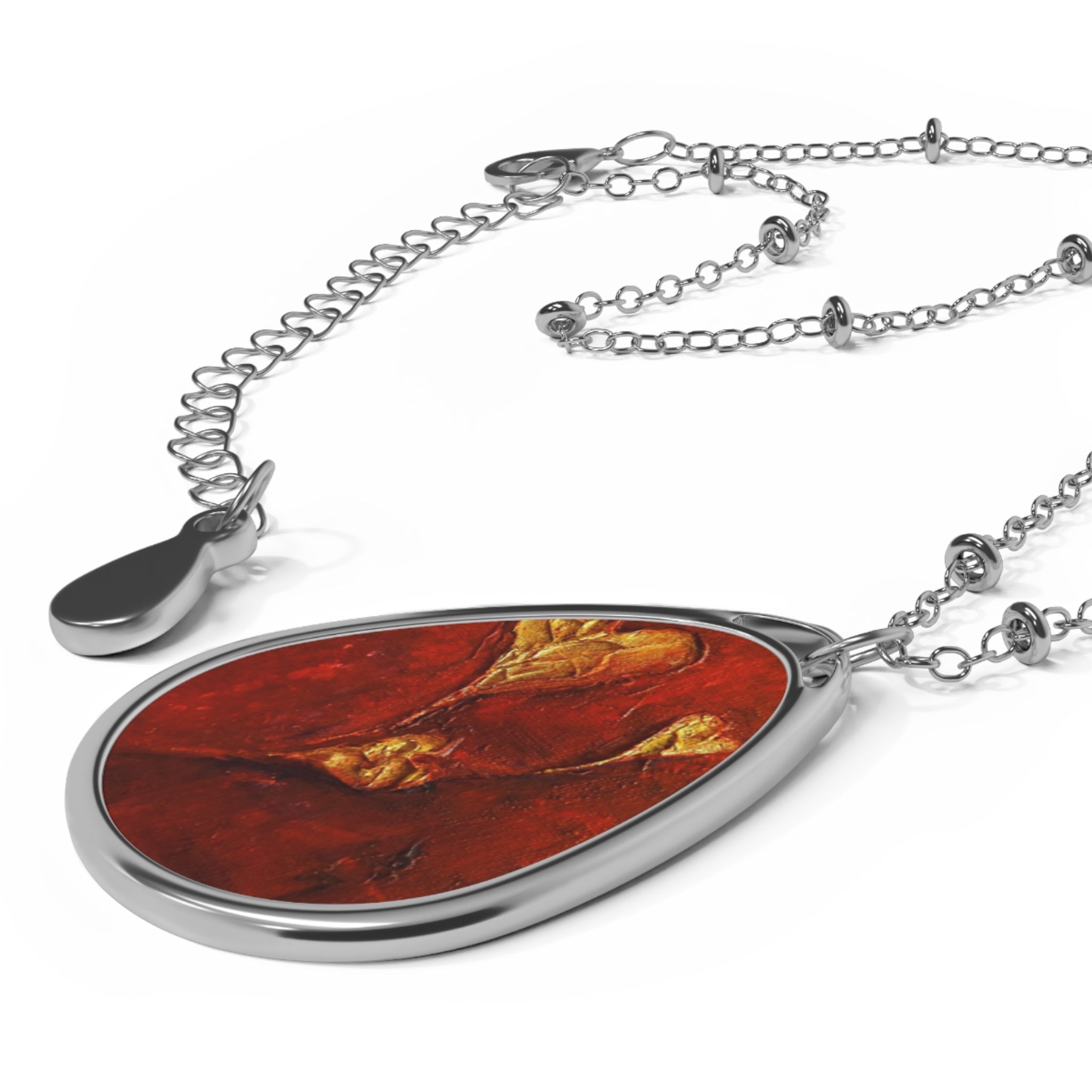 Silver teardrop pendant with red and gold abstract art design on delicate silver chain