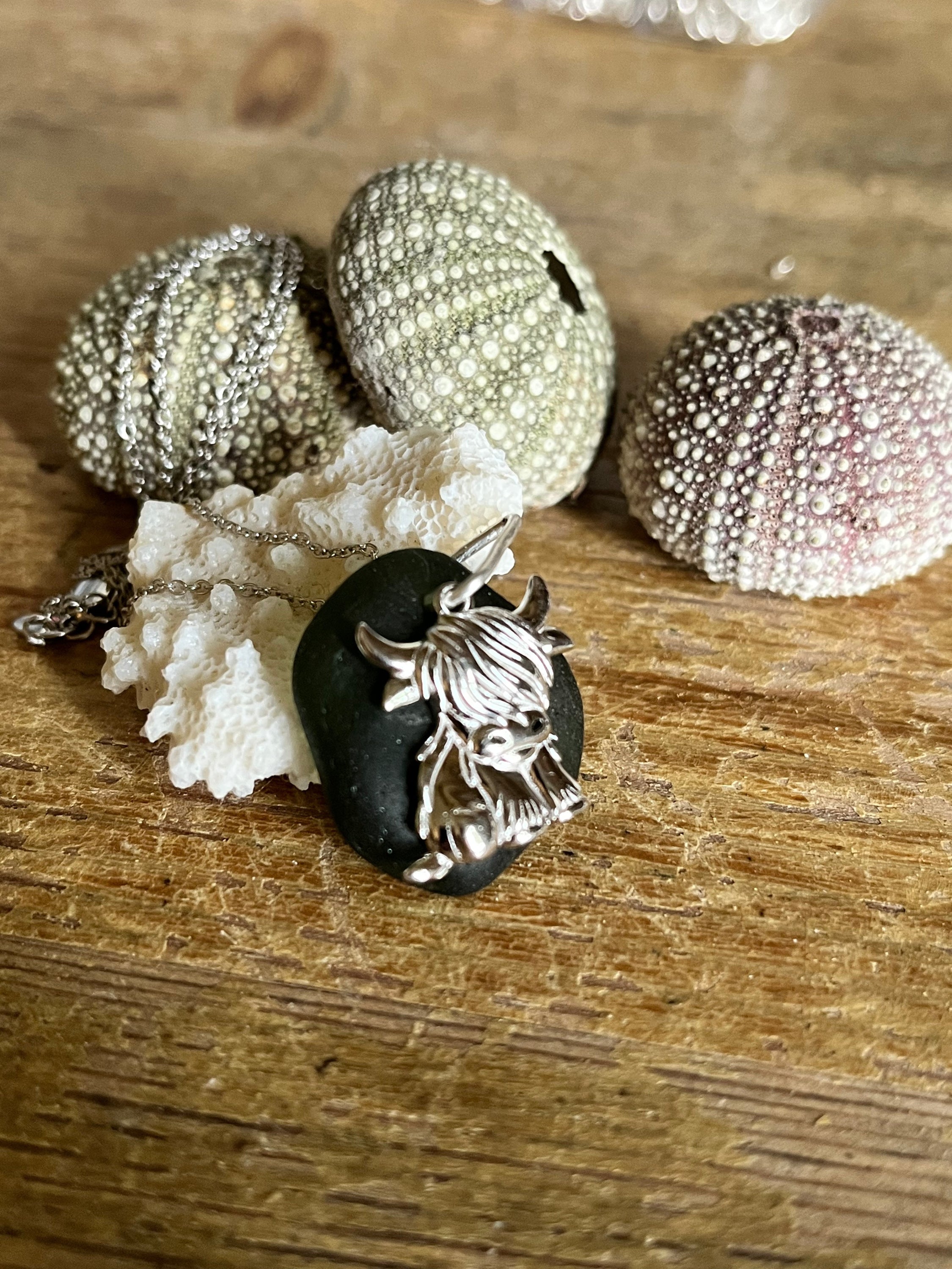 Silver Highland Cow Pendant on dark smooth stone for Highland Cow Pendants 925