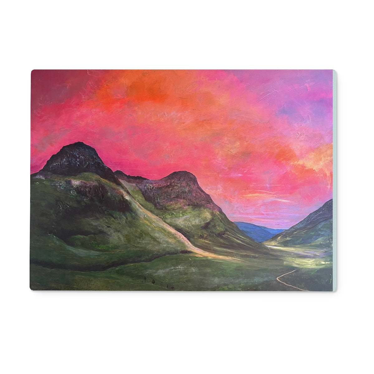 Pink orange sunset over Glencoe mountains on chopping board