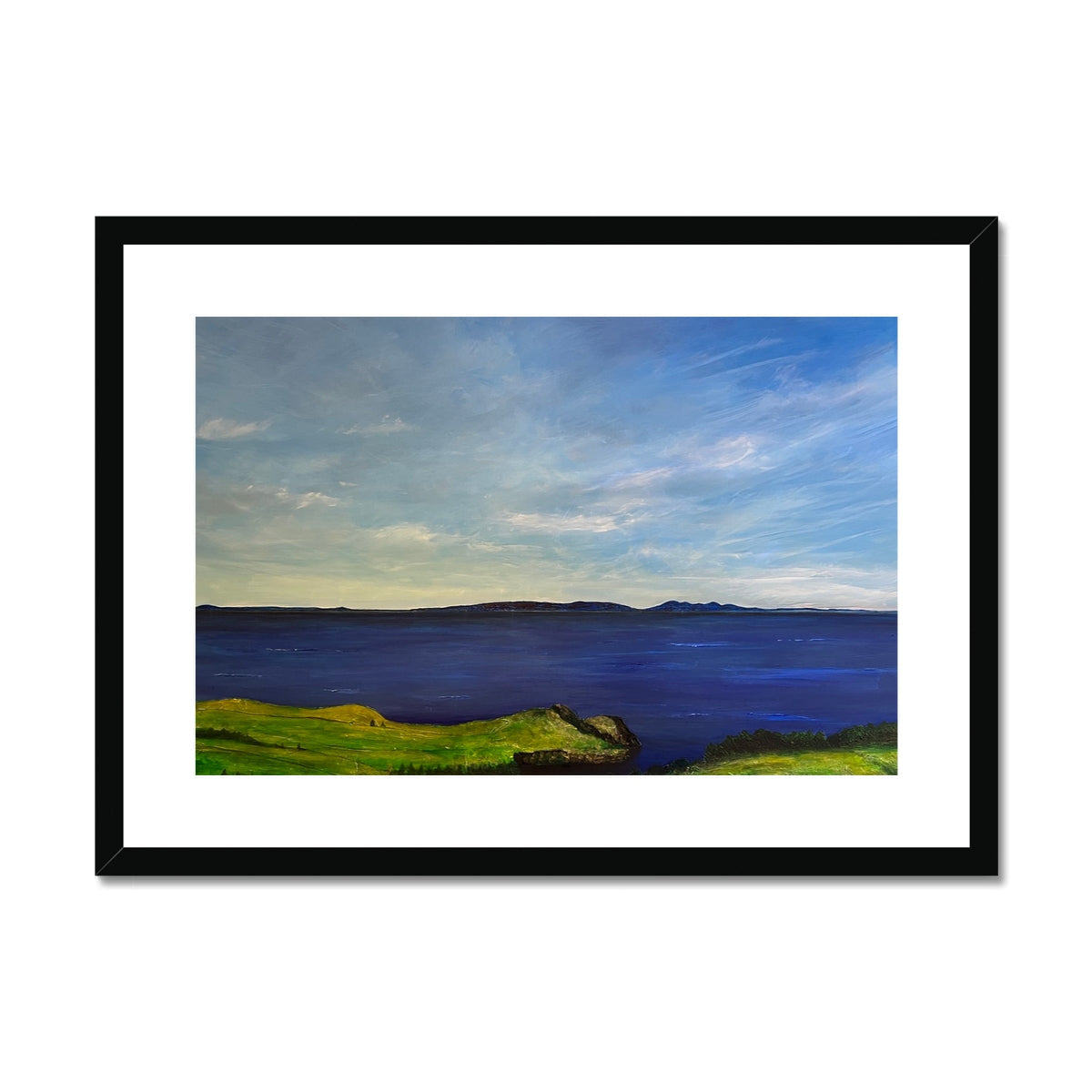 Black-framed canvas print of Irish coastal landscape with green grass and blue sky