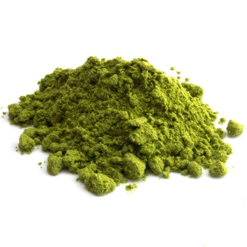 Ceremonial grade Japanese matcha powder mound, vibrant green and clumpy