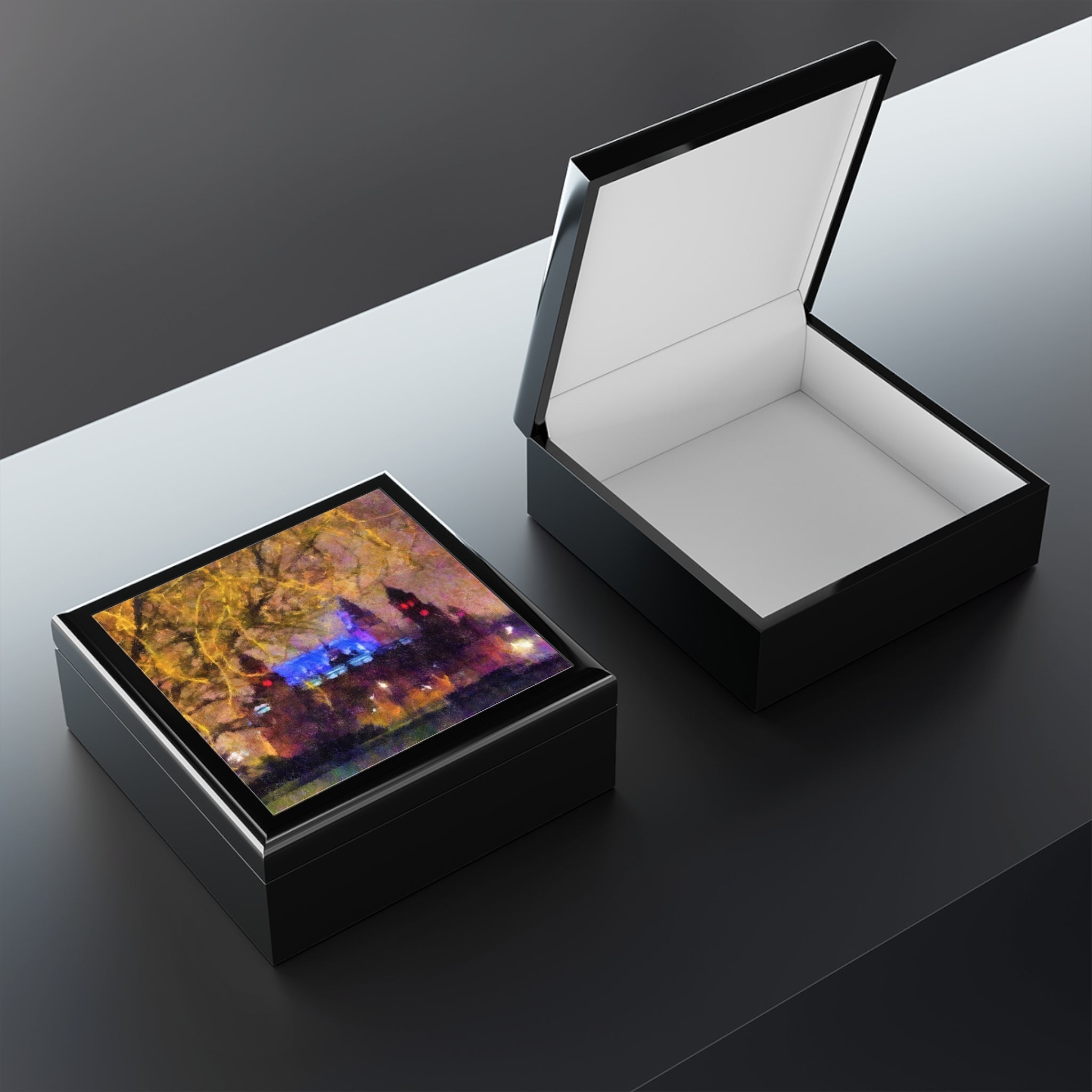 Kelvingrove Nights jewelry box: black glossy square with open lid showing white interior and vibrant abstract artwork