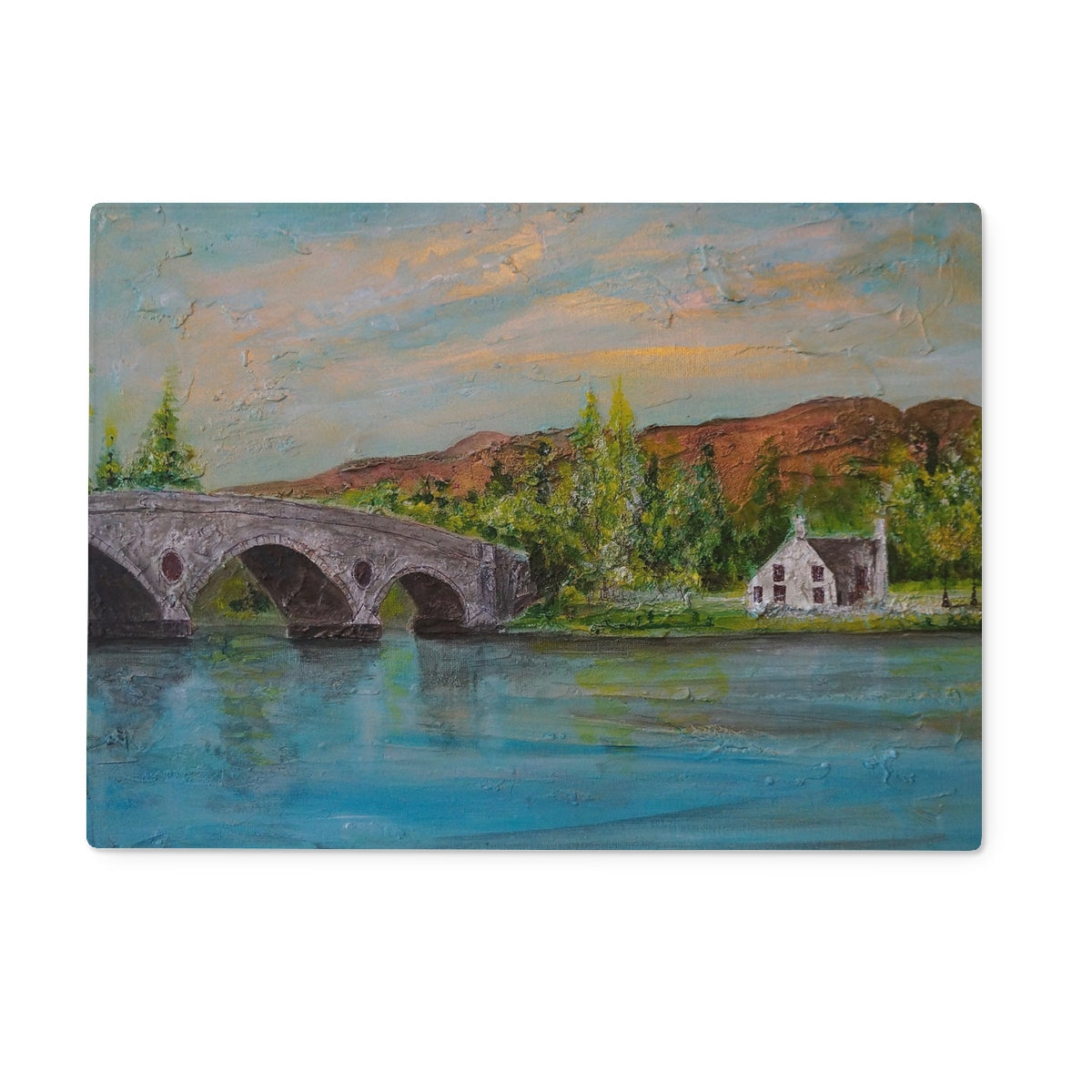 Kenmore Bridge II glass chopping board with stone bridge puzzle piece, house and trees