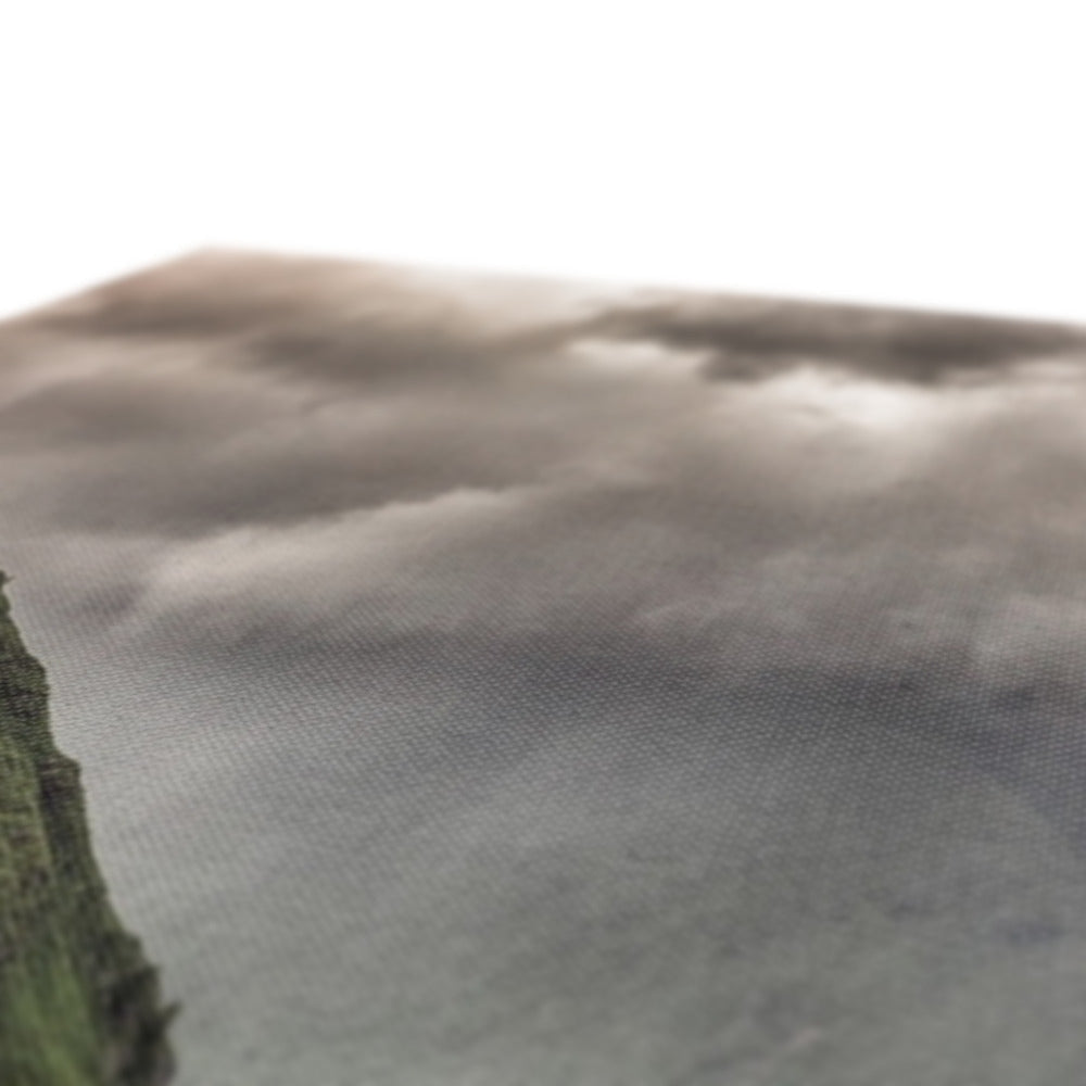 Kilchurn Castle brown cliff edge with green vegetation and gray water