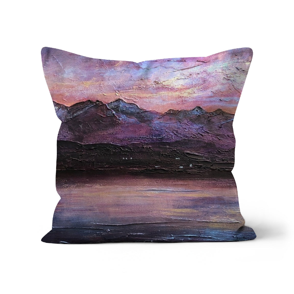 Decorative throw pillow with impressionistic mountain and lake landscape in purple and pink hues