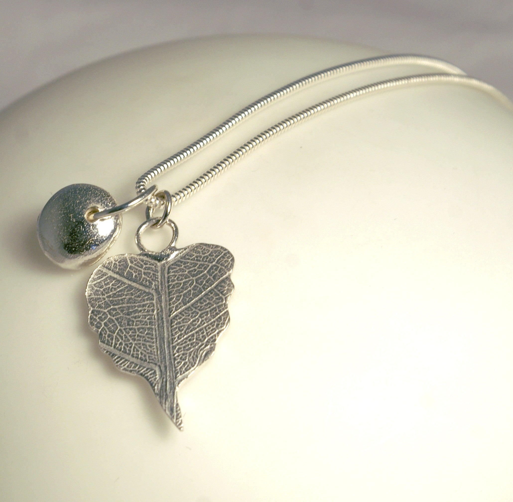 Silver leaf pendant necklace with textured vein design and nugget charm by Genna Miller Jewellery