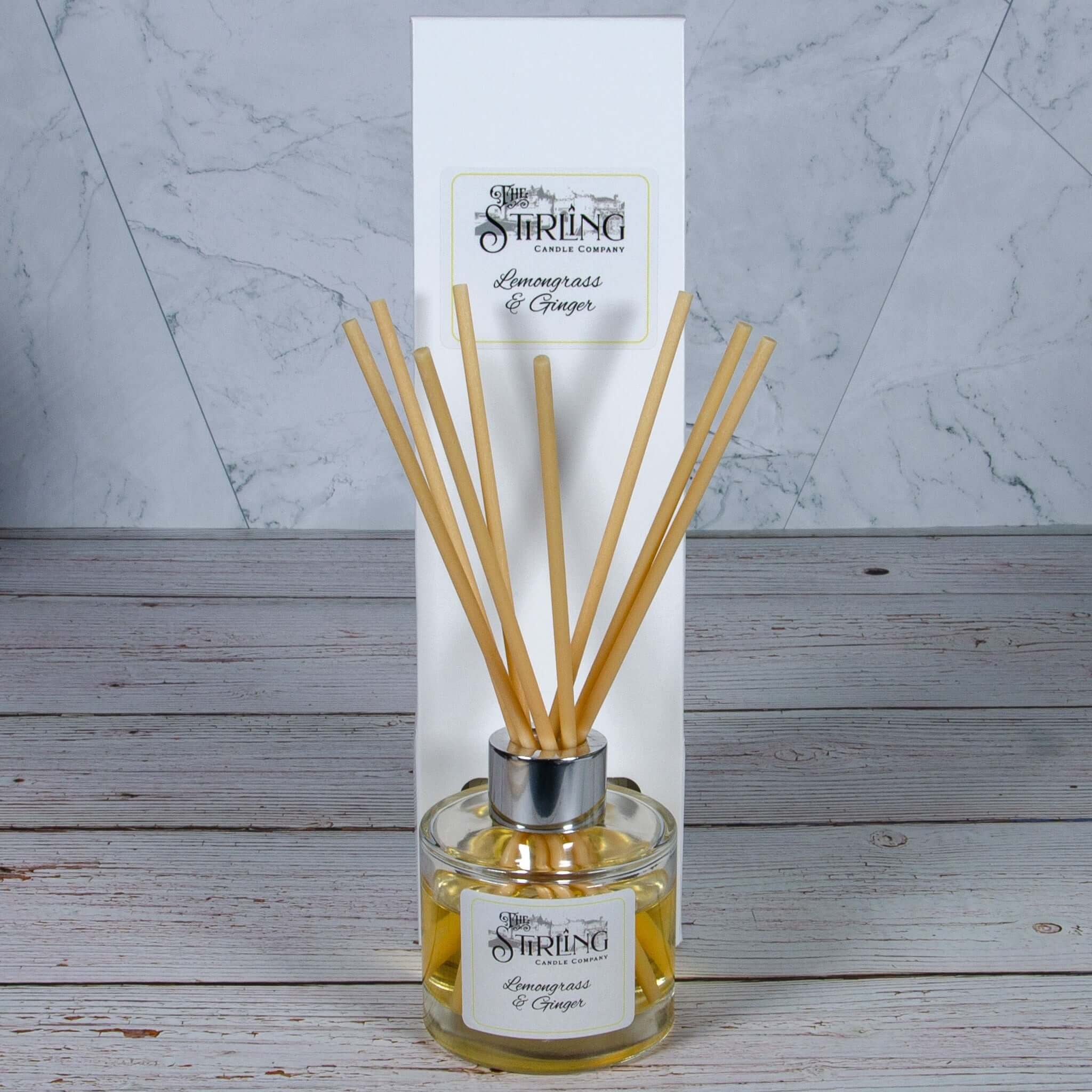 Lemongrass and ginger scented reed diffuser in clear glass bottle with silver cap and wooden reeds, 100ml