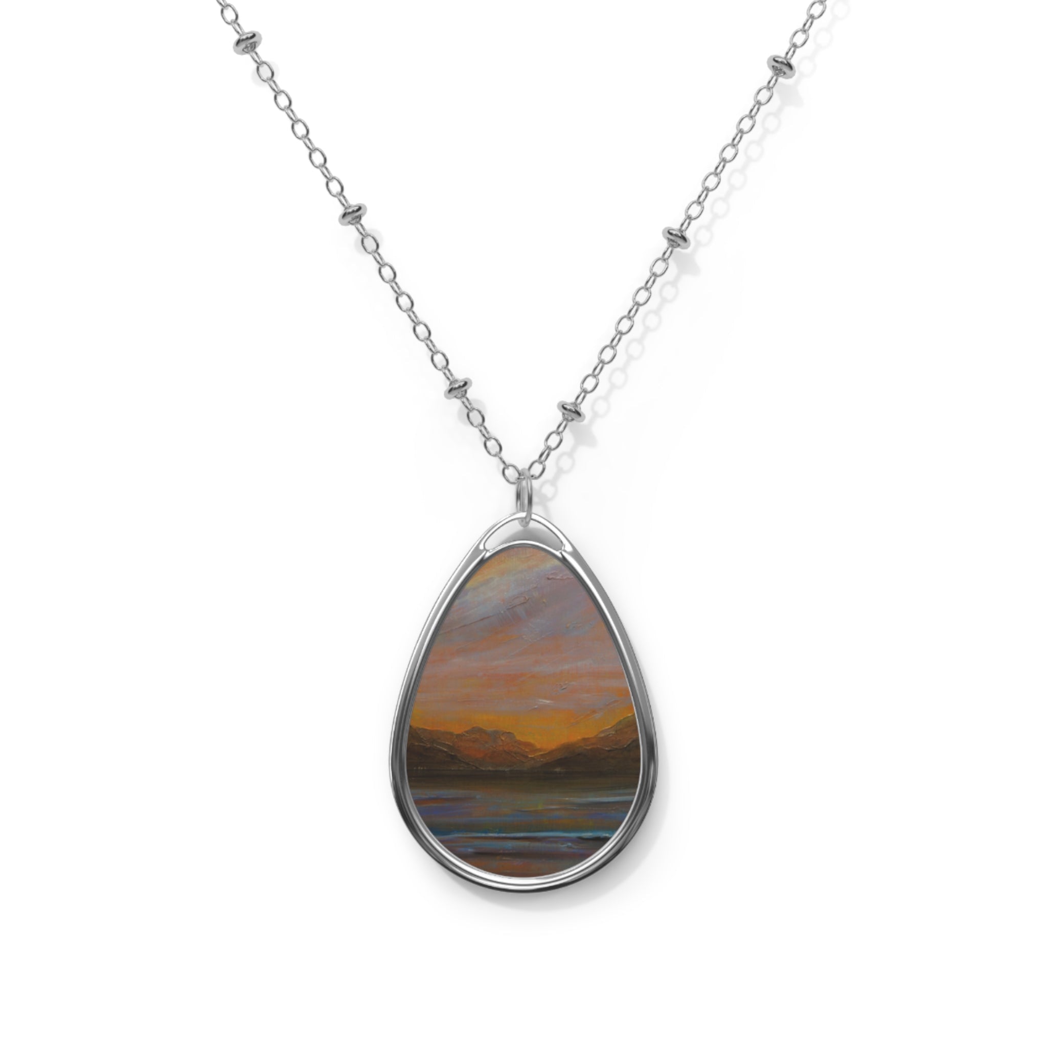Silver chain necklace with oval pendant featuring a sunset landscape of Loch Lomond