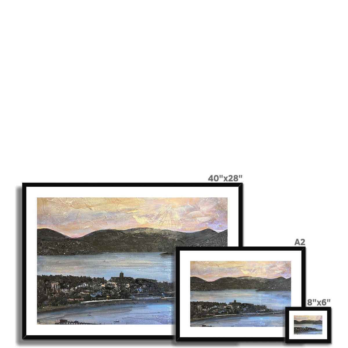 Framed landscape print of mountains and water at dusk with black frame and white mat
