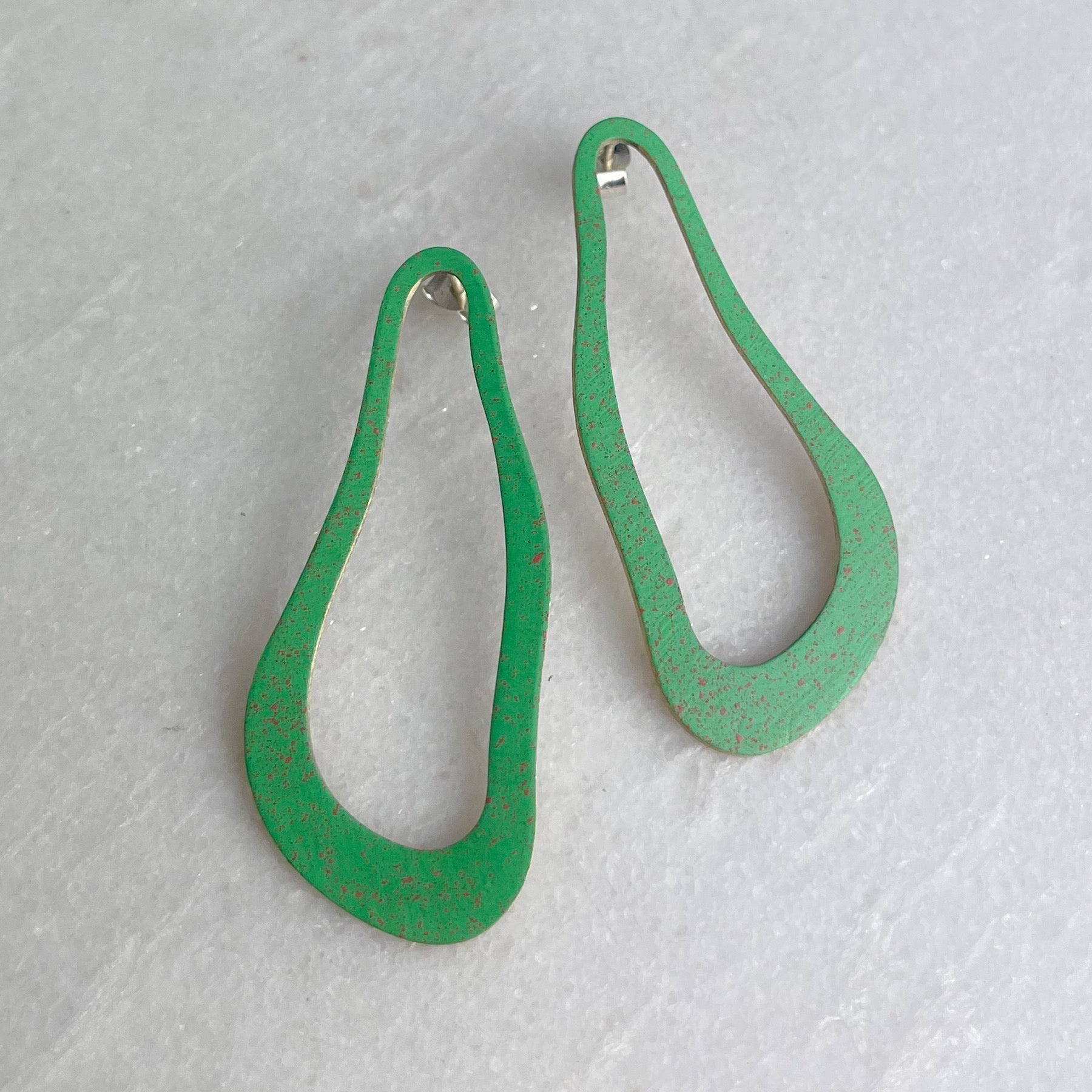 Green pear-shaped Masca Dali earrings with speckled finish and silver hooks by Lindsay Mcdowall Jewellery