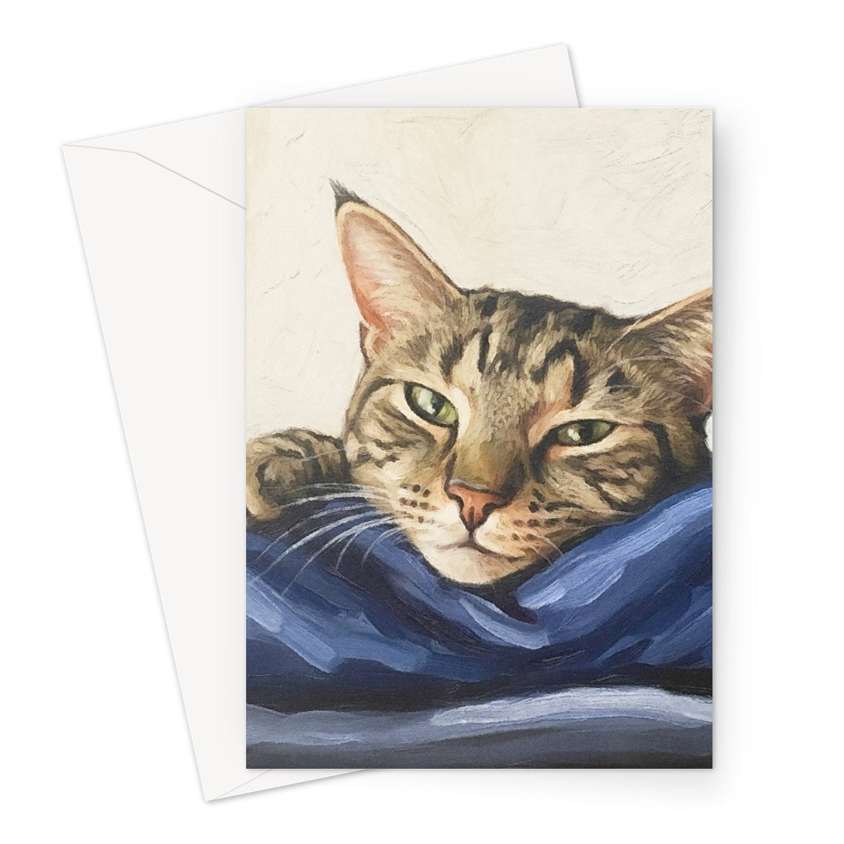 Mitzi tabby cat pet portrait greeting card with green eyes on blue fabric