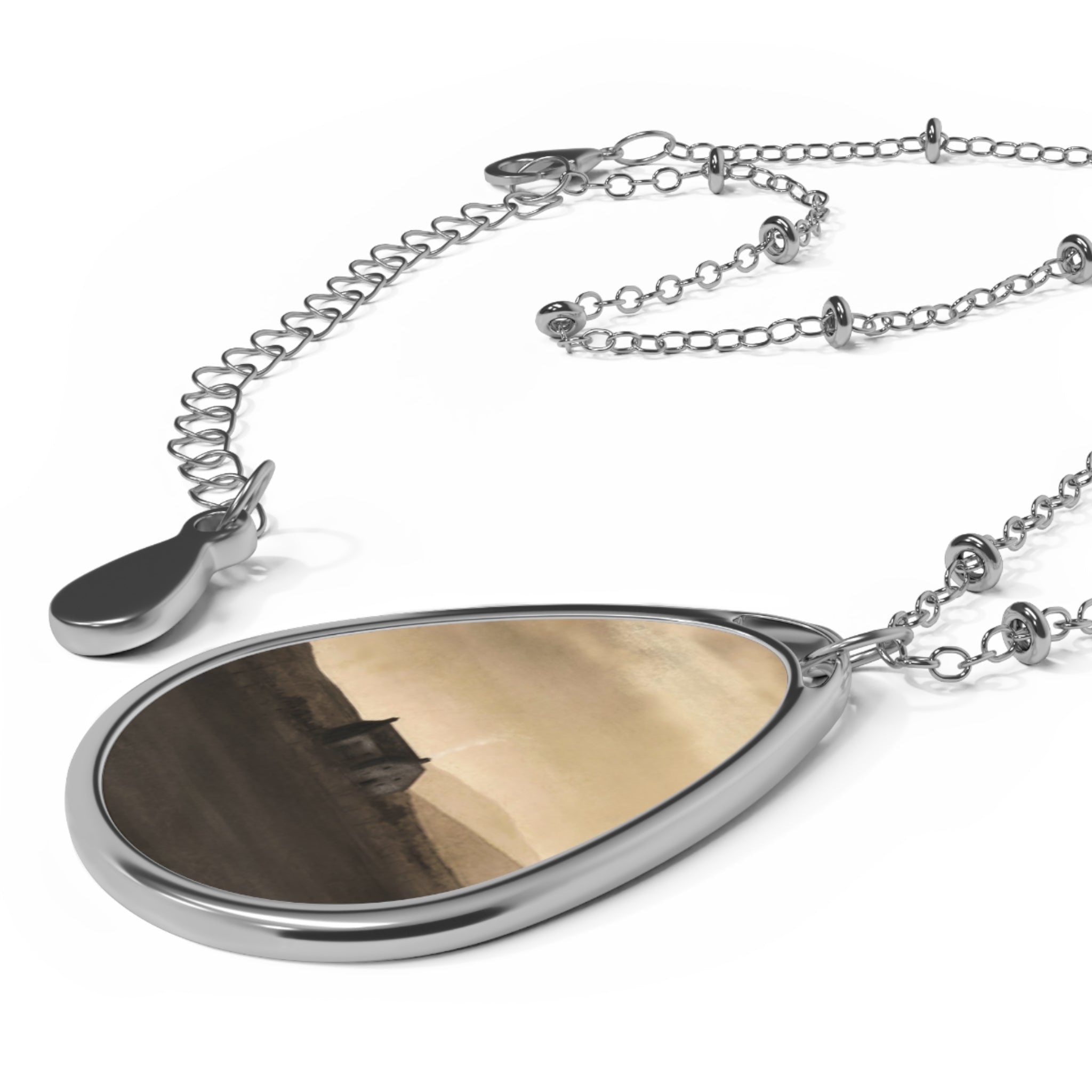 Silver teardrop pendant with desert landscape art on a delicate silver chain with beads