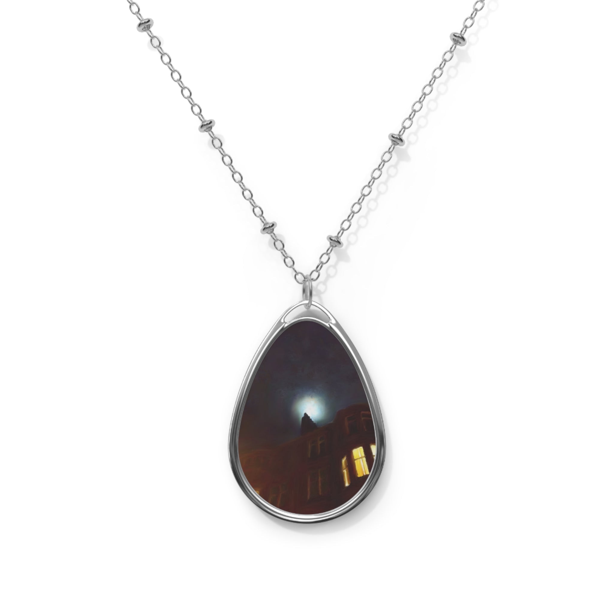 Silver chain necklace with dark-hued oval pendant reflecting light and architectural details