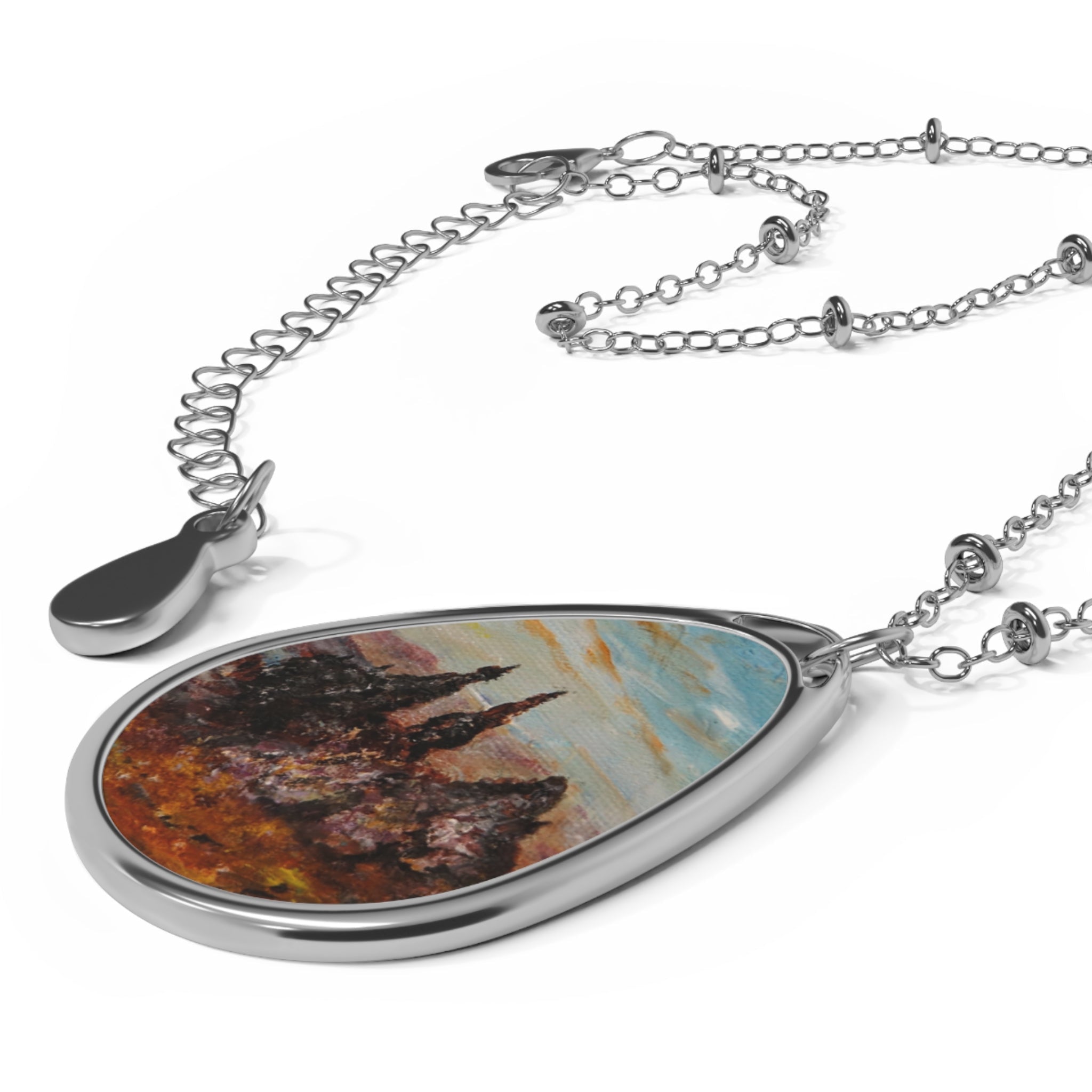 Silver-tone teardrop pendant necklace with abstract landscape insert inspired by The Old Man Of Storr Skye