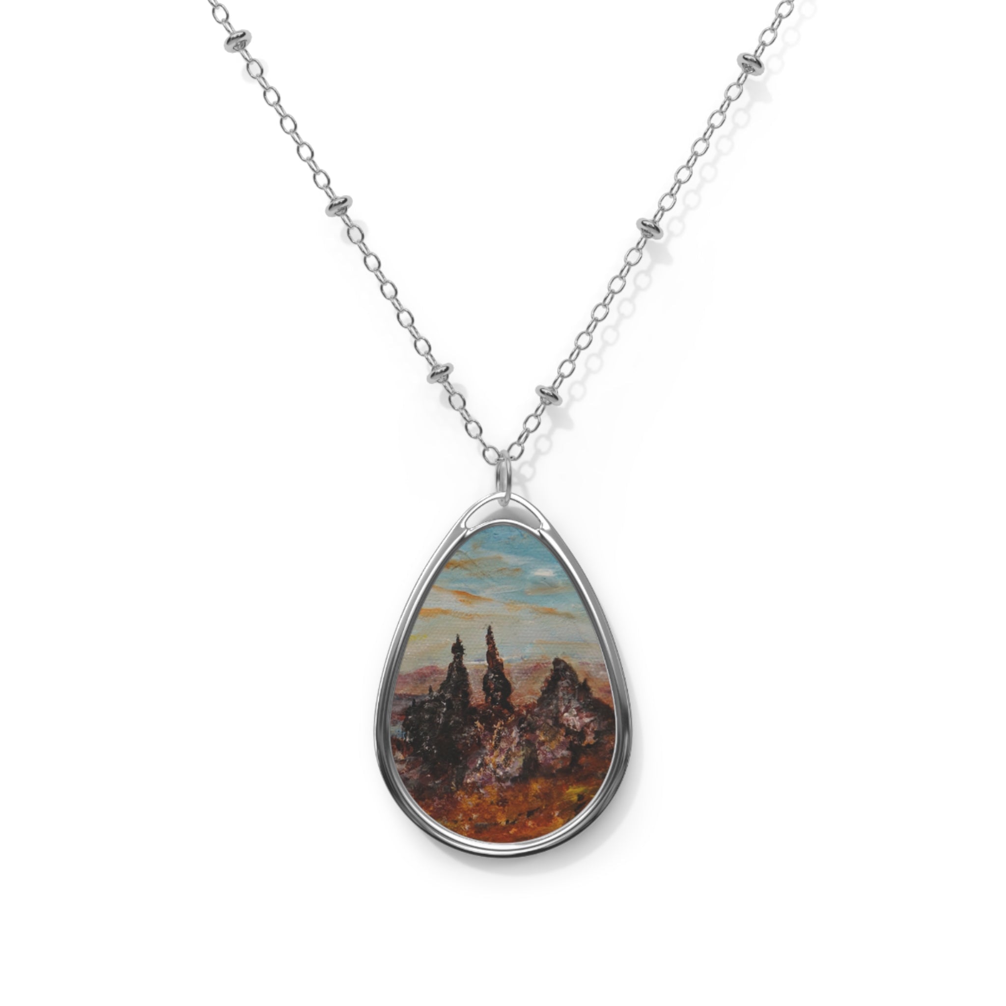 Silver chain necklace with a teardrop pendant showcasing a painted landscape of The Old Man Of Storr Skye