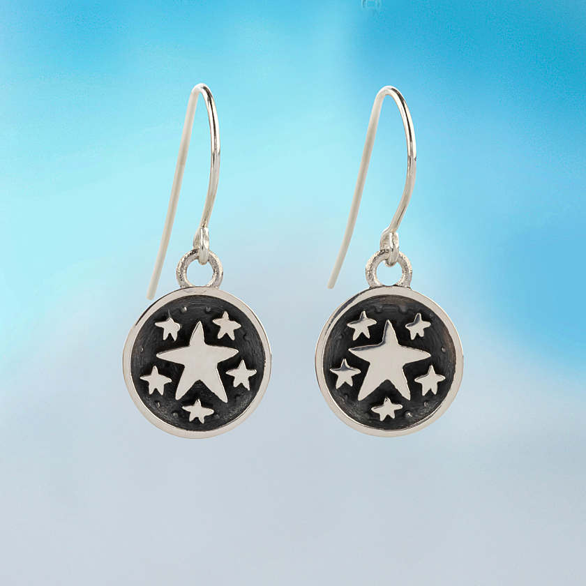 Silver star-themed dangle earrings with blackened circular design and multiple white stars one in a zillion earrings