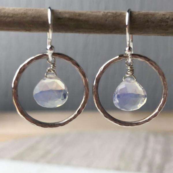 Silver hoop earrings with faceted translucent blue moonstone drops called opalite hoop earrings