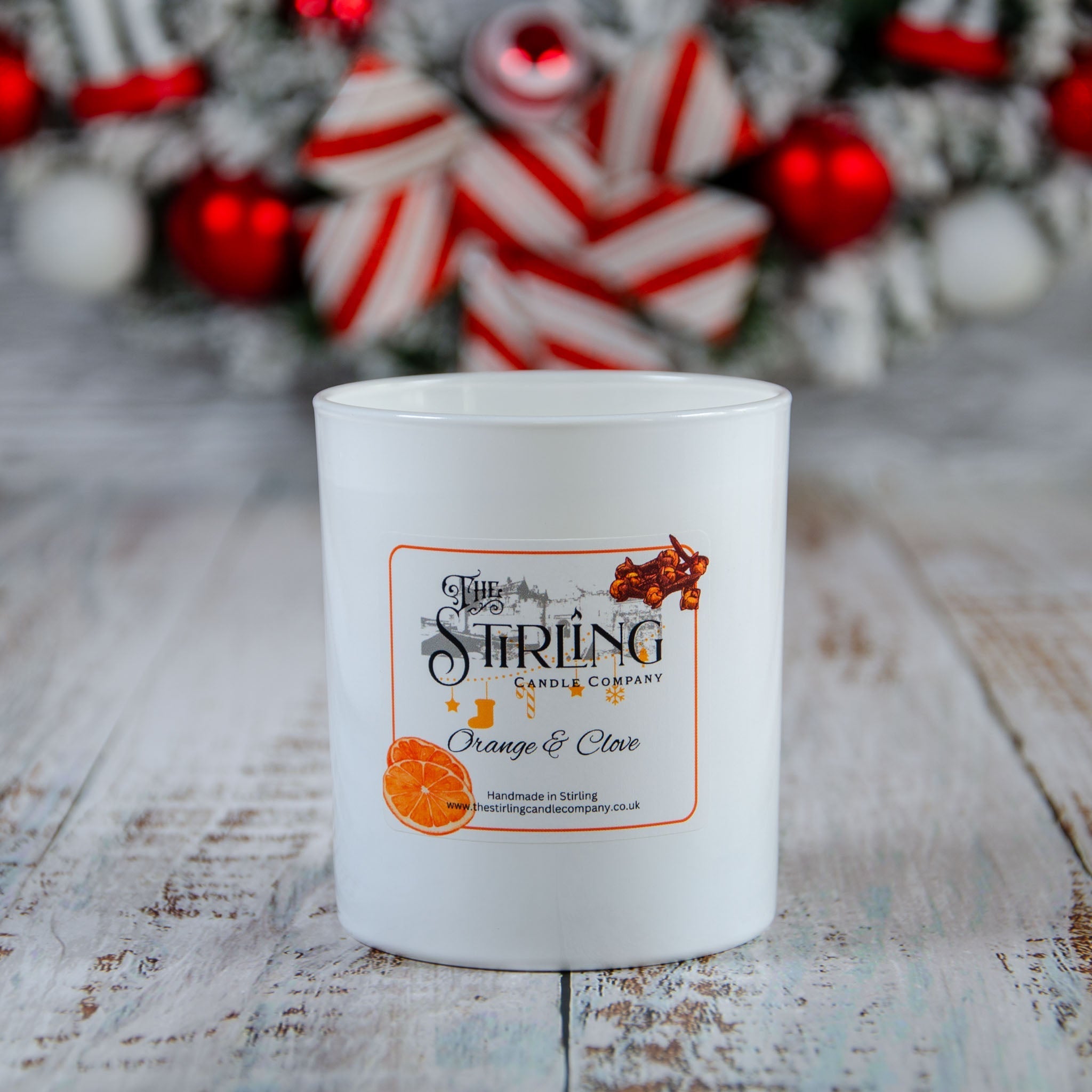White ceramic jar of Stirling Candle Company’s Orange & Clove large candle
