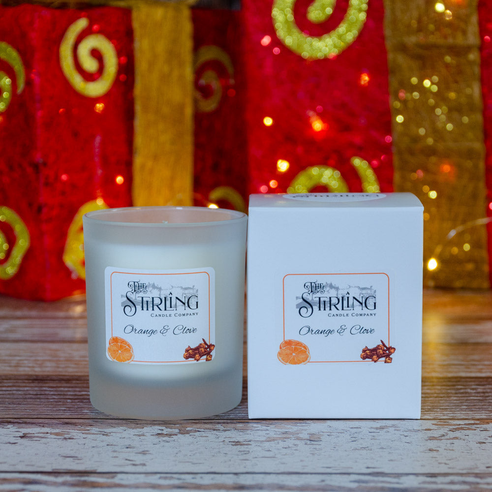 Orange & Clove medium candle in frosted jar with Stirling label beside box