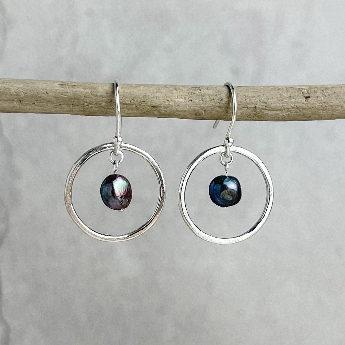 Silver hoop earrings with dangling iridescent pearls by Lindsay Mcdowall Jewellery
