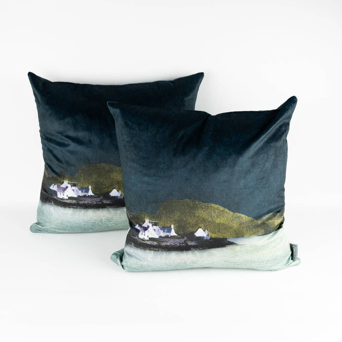 Dark teal Plockton velvet cushion by Cath Waters with coastal village print