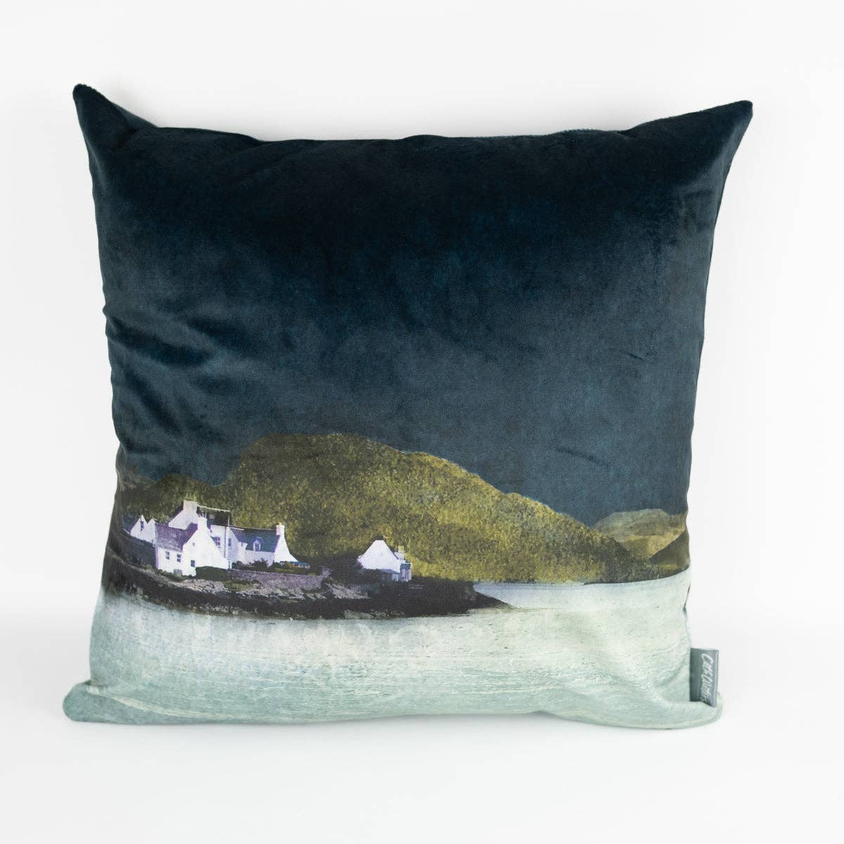 Plockton velvet cushion in dark teal with printed landscape of white cottages by green hills and water