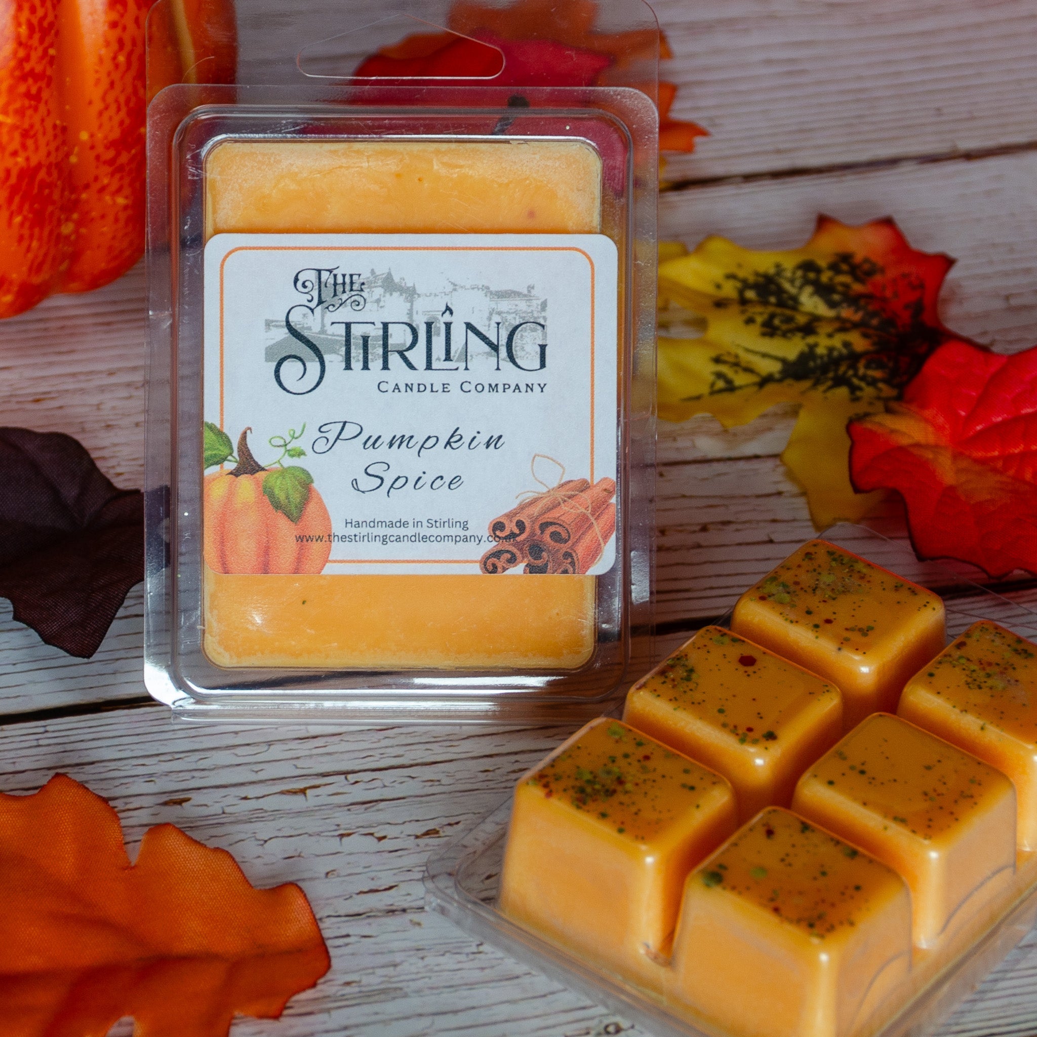 Orange pumpkin spice wax melt clamshell in clear plastic container with white label from Stirling Candle Company